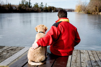 Man and Dog on Dock by Water